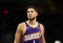 NBA Picks & Predictions Today (Dec. 23): Best Bets on Sides & Totals Suns superstar Devin Booker looks on against the Warriors during the 2025-26 NBA season.