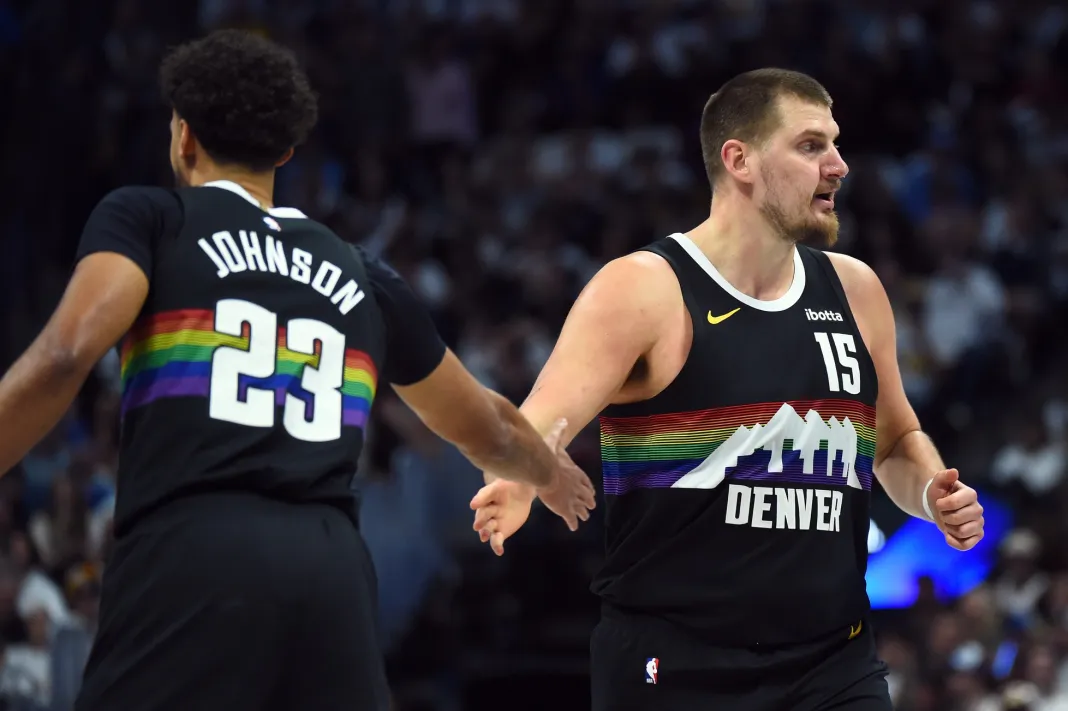 NBA: Houston Rockets at Denver Nuggets Nuggets superstar Nikola Jokic high fives Cam Johnson in a game against the Rockets during the 2025-26 NBA season.