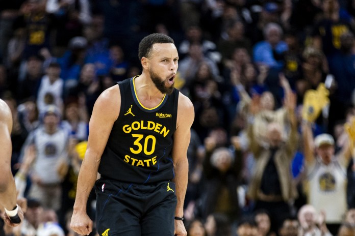 Warriors star Stephen Curry celebrates a shot against the Suns during the 2025-26 NBA season.