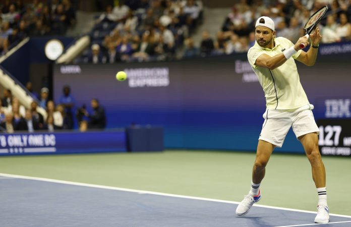 Grigor Dimitrov looks to hit a backhand against Frances Tiafoe at the 2024 US Open.