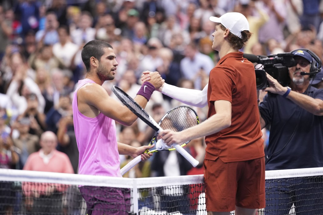 Carlos Alcaraz and Jannik Sinner meet at the net at the 2025 US Open.
