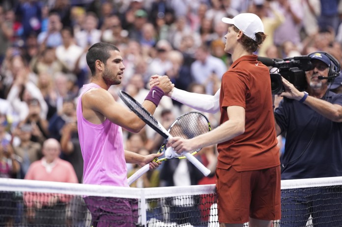 Carlos Alcaraz and Jannik Sinner meet at the net at the 2025 US Open.