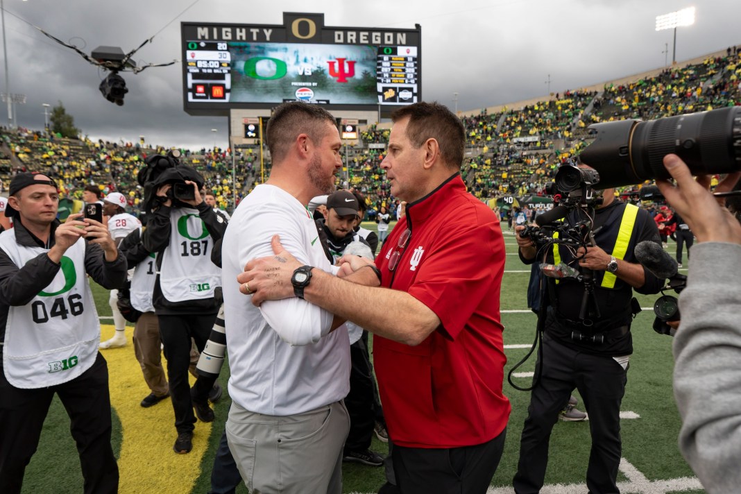 Dan Lanning, left, shakes hands with Indiana head coach Curt Cignetti as the Oregon Ducks host the Indiana Hoosiers.