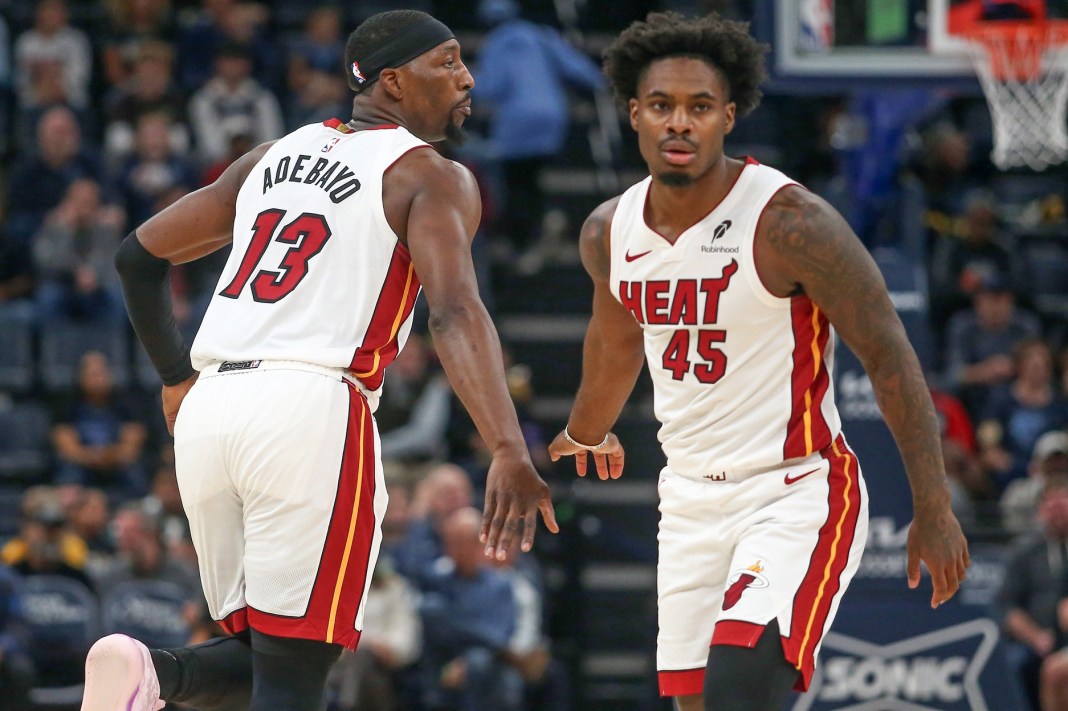 Heat players Davion Mitchell and Bam Adebayo react to a play against the Grizzlies during the 2025-26 NBA season.