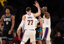 NBA Picks & Predictions Today (Jan. 6): Best Bets on Sides & Totals Lakers superstars Luka Doncic and LeBron James high five during a meeting with the Grizzlies in the 2025-26 NBA season.