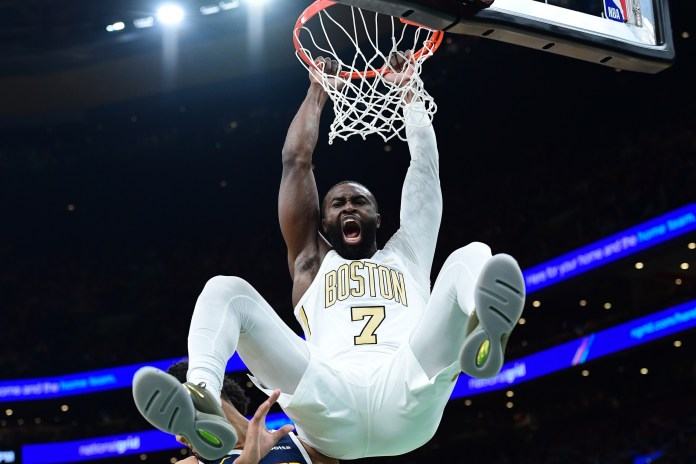 Celtics superstar Jaylen Brown dunks against the Nuggets during the 2025-26 NBA season.