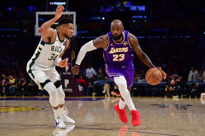 Lakers superstar LeBron James drives on Giannis Antetokounmpo against the Bucks during the 2025-26 NBA season.