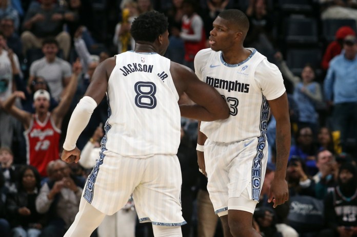 Grizzlies players Jaren Jackson Jr. and Cedric Coward react to a play against the Nets during the 2025-26 NBA season.