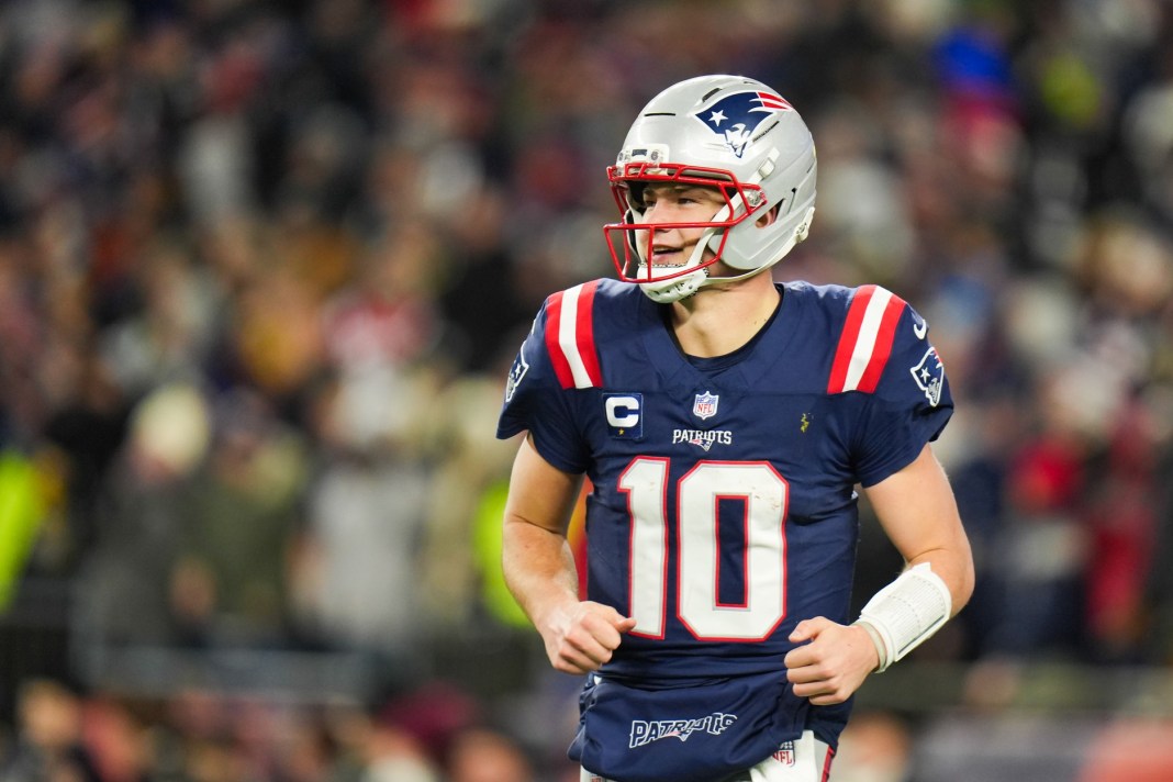 Patriots star Drake Maye runs around the field in a meeting with the Chargers in the NFL Playoffs.