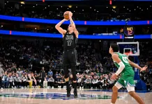 NBA Picks & Predictions Today (Jan. 14): Best Bets on Sides & Totals Nets forward Michael Porter Jr. takes a shot against the Mavericks during the 2025-26 NBA season.