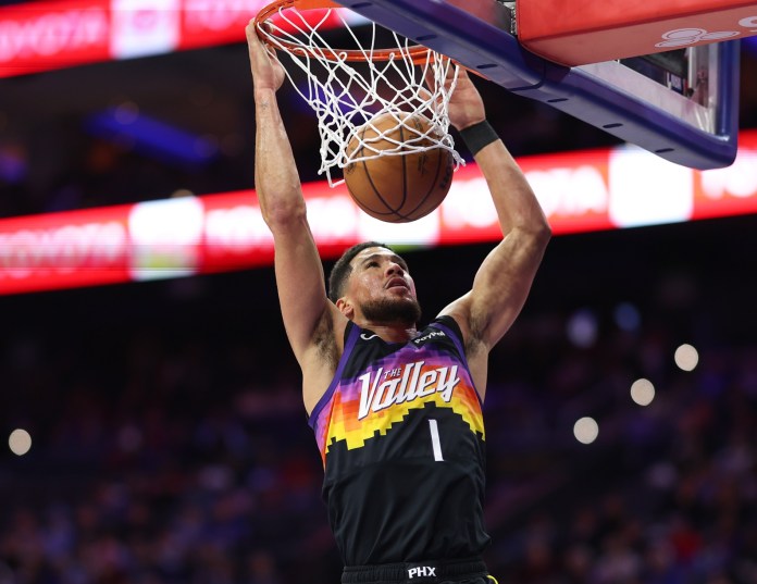 Suns superstar Devin Booker dunks against the 76ers during the 2025-26 NBA season.