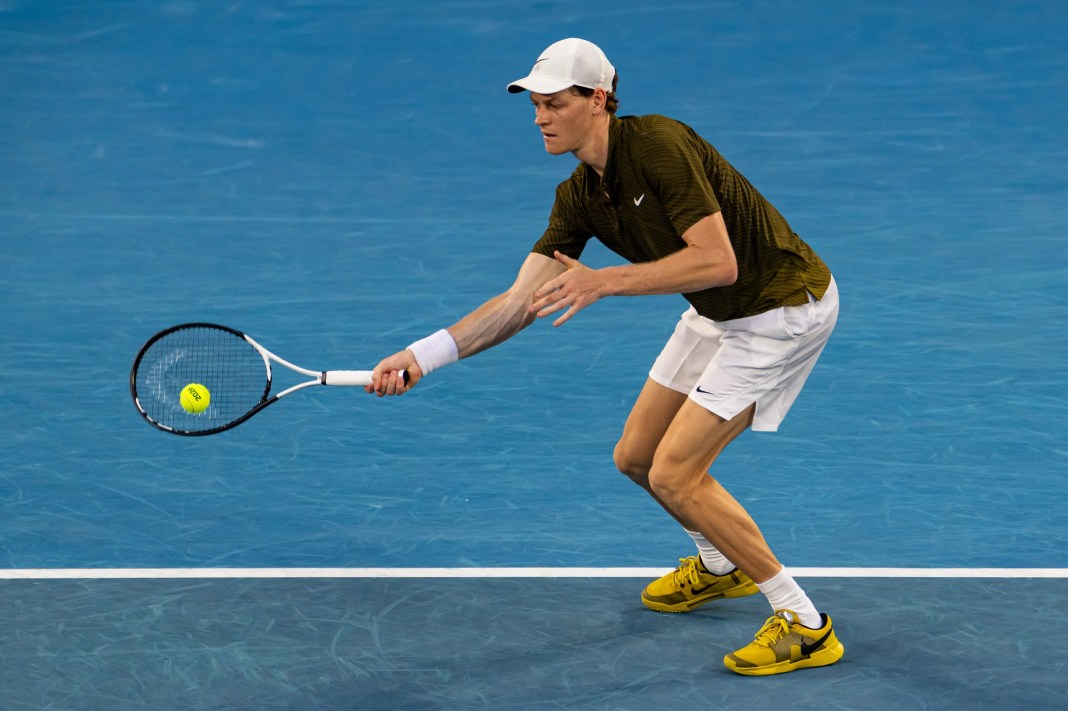 Jannik Sinner hits a forehand against Luciano Darderi during the 2026 Australian Open.