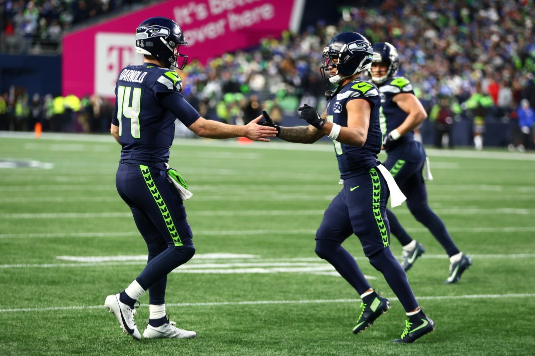 Seahawks stars Sam Darnold and Jaxon Smith-Njigba celebrate a play against the Rams in the 2026 NFC Championship Game.