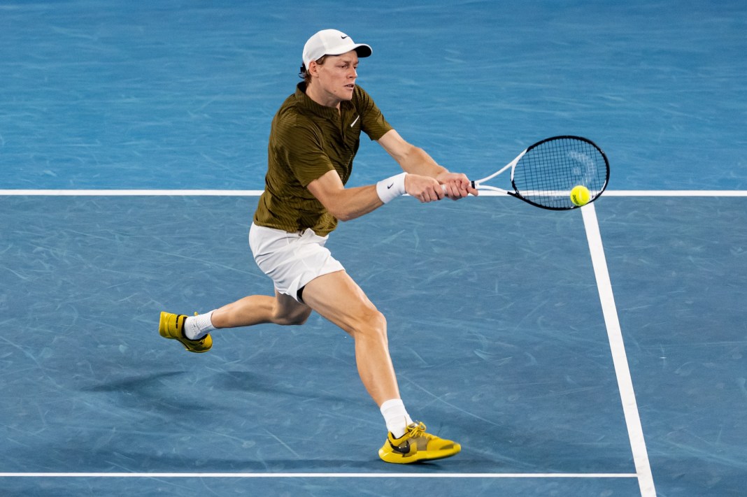 Jannik Sinner hits a backhand against Novak Djokovic at the 2026 Australian Open.