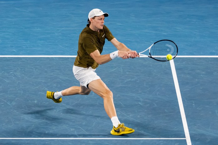 Jannik Sinner hits a backhand against Novak Djokovic at the 2026 Australian Open.
