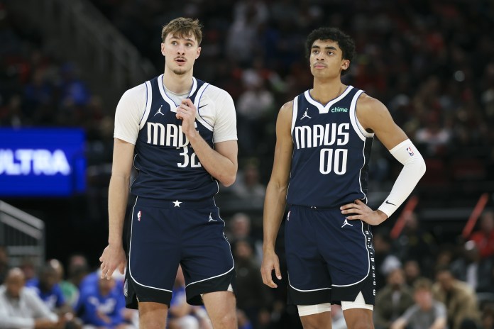 Mavericks players Cooper Flagg and Max Christie talk during a meeting with the Rockets in the 2025-26 NBA season.
