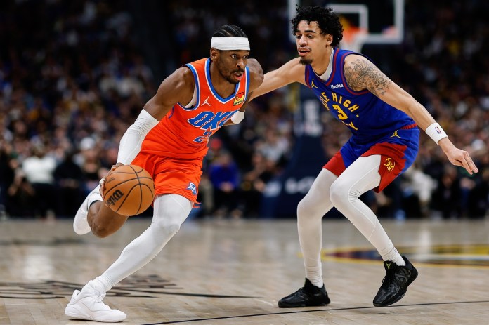 Thunder star Shai Gilgeous-Alexander drives to the rim against the Nuggets during the 2025-26 NBA season.