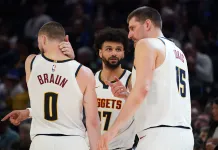 NBA Picks & Predictions Today (March 5): Best Bets on Sides & Totals Nuggets players Nikola Jokic, Jamal Murray, and Christian Braun huddle against the Warriors during the 2025-26 NBA season.