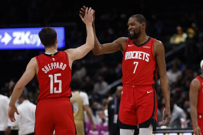 Rockets players Reed Sheppard and Kevin Durant react to a play against the Wizards during the 2025-26 NBA season.