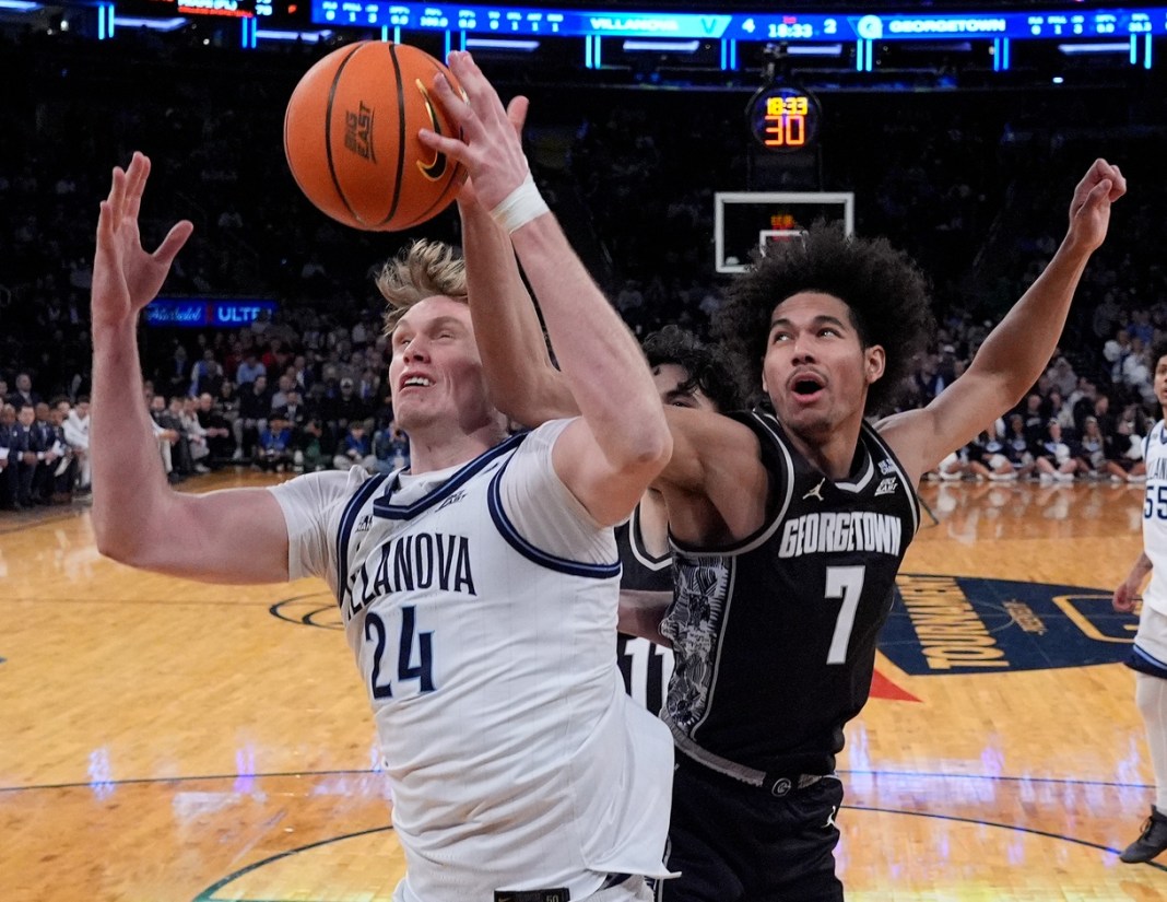 Villanova Wildcats forward Duke Brennan (24) and Georgetown Hoyas forward Isaiah Abraham (7) fight for ball.