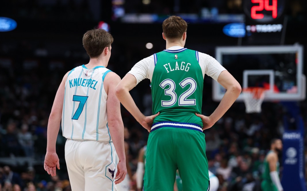 Hornets rookie Kon Knueppel and Mavericks rookie Cooper Flagg stand in a meeting during the 2025-26 NBA season.