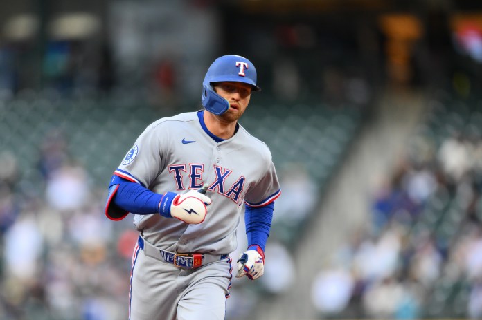 Rangers outfielder Brandon Nimmo hits a home run against the Mariners during the 2026 MLB season.