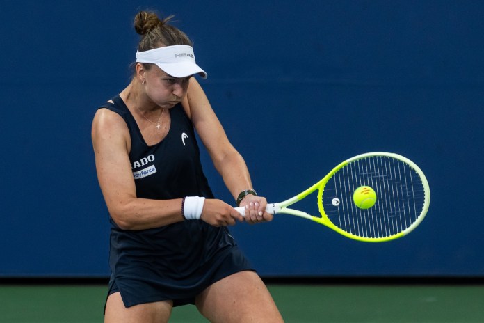 Barbora Krejcikova hits a backhand against Emma Navarro at the 2025 US Open.