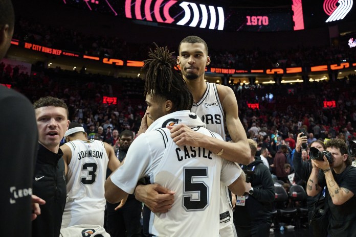 Spurs stars Victor Wembanyama and Stephon Castle celebrate a win over the Trail Blazers in the 2025-26 NBA Playoffs.