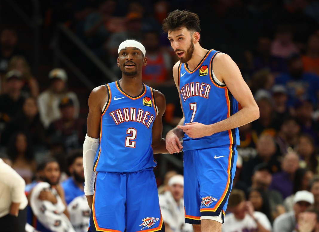 Thunder stars Shai Gilgeous-Alexander and Chet Holmgren talk during a game against the Suns during the 2025-26 NBA Playoffs.
