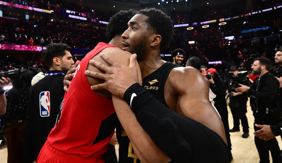 Cavaliers guard Donovan Mitchell (45) hugs Toronto Raptors forward Scottie Barnes.