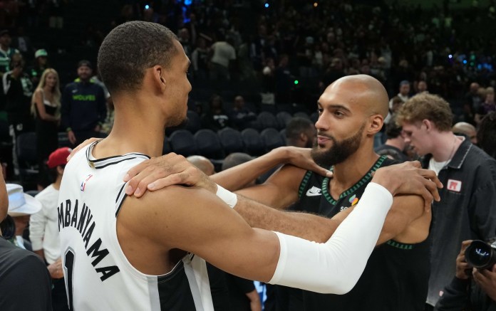 San Antonio Spurs forward Victor Wembanyama (1) talks with Minnesota Timberwolves center Rudy Gobert