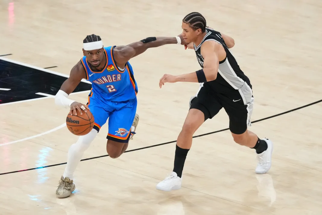 NBA: Playoffs-Oklahoma City Thunder at San Antonio Spurs Thunder star Shai Gilgeous-Alexander drives against Carter Bryant during the 2025-26 NBA Playoffs.