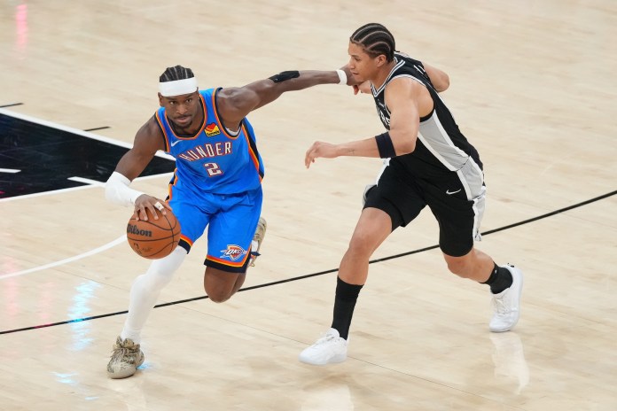 Thunder star Shai Gilgeous-Alexander drives against Carter Bryant during the 2025-26 NBA Playoffs.