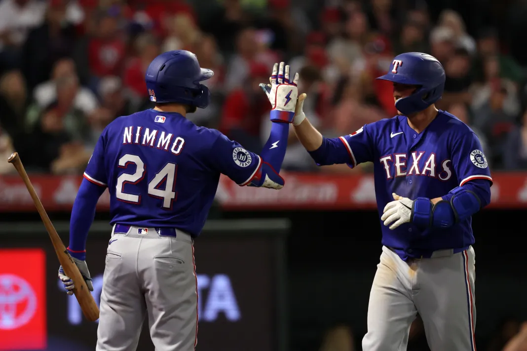 MLB: Texas Rangers at Los Angeles Angels Rangers players Kyle Higashioka and Brandon Nimmo celebrate against the Angels during the 2026 MLB season.