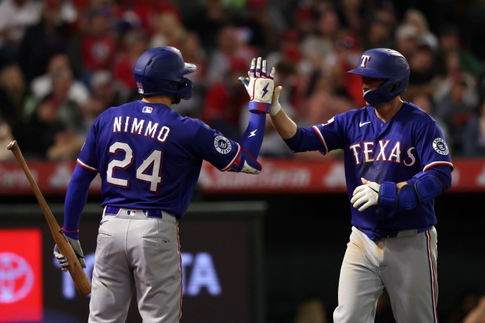 Rangers players Kyle Higashioka and Brandon Nimmo celebrate against the Angels during the 2026 MLB season.