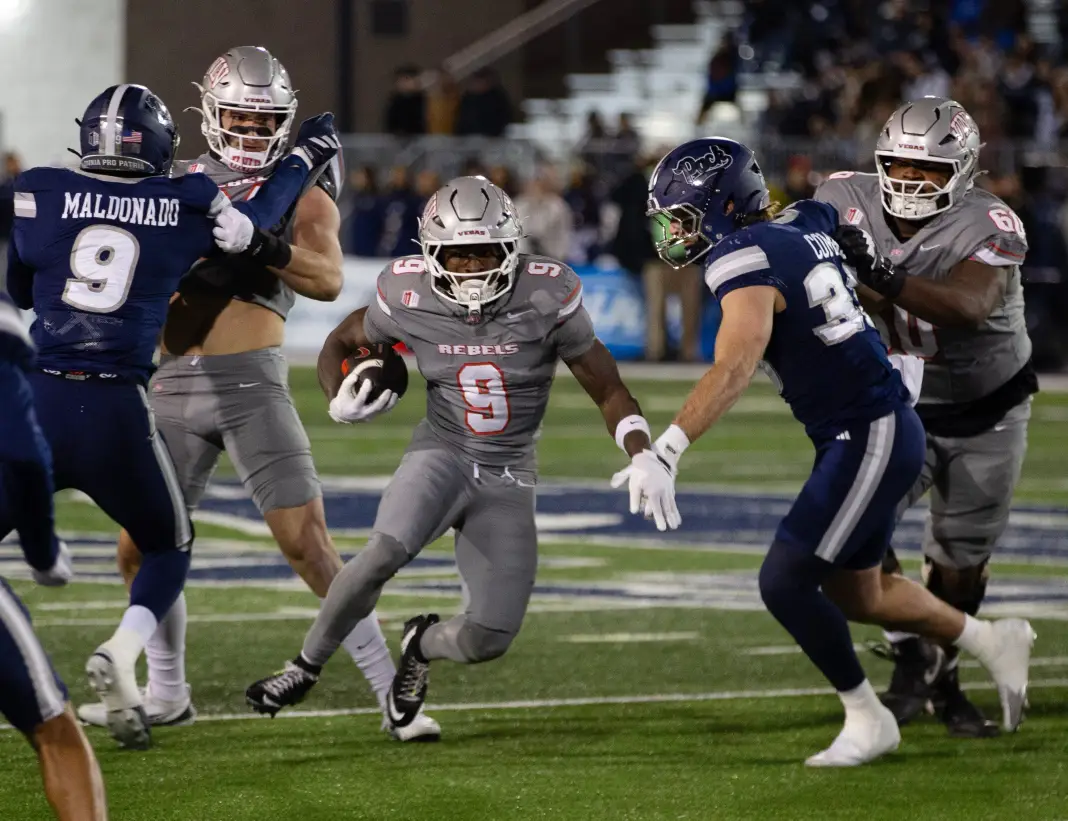 UNLV running back Jai'Den Thomas (9) runs against Nevada in the first half of an NCAA college football game in Reno, Nev., week 0 college football odds report lines