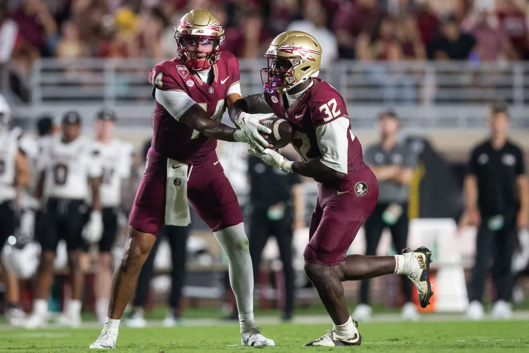 Florida State Seminoles quarterback Ashton Daniels (14) hands the ball off to Florida State Seminoles running back Ousmane