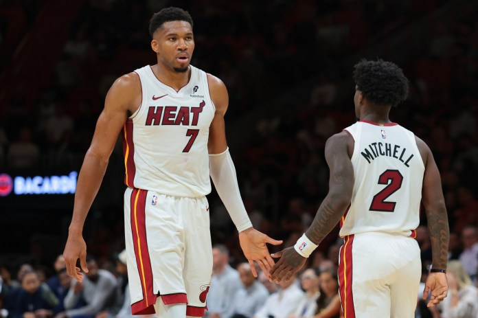 Heat star Giannis Antetokounmpo with Davion Mitchell.
